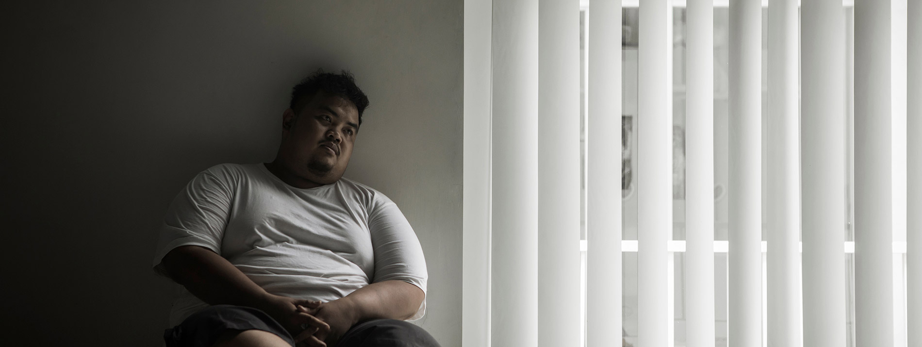 Man relaxing in a dark corner.