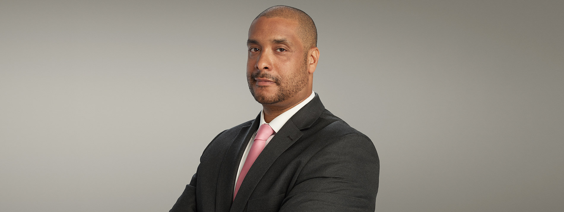 Centered portrait of a man wearing suit and tie.